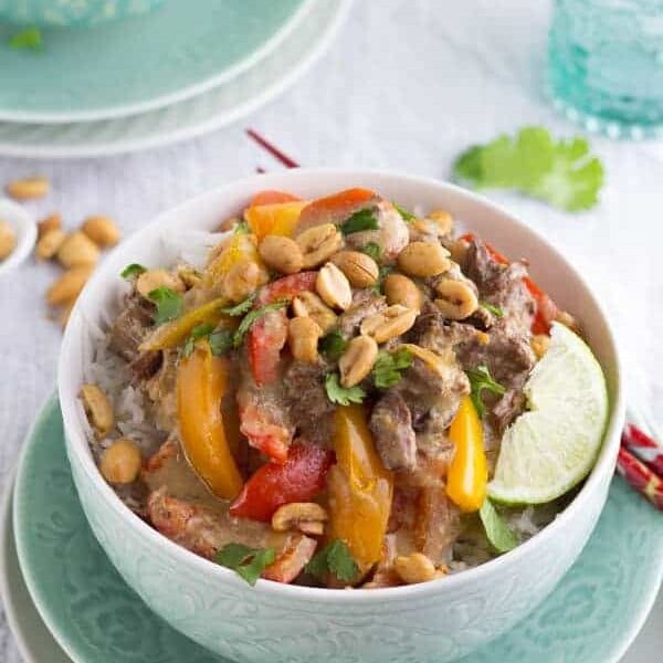thai curry beef in white bowl with lime slice
