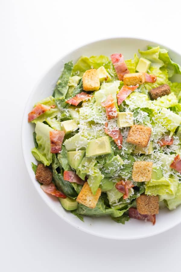 overhead shot of a bowl of avocado caesar salad