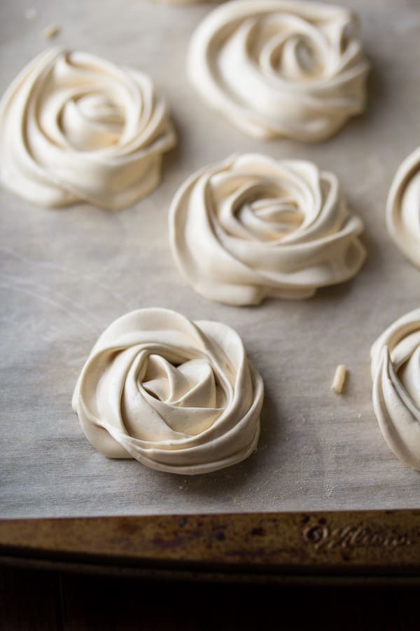 meringue cookies on parchment lined baking sheet before baking