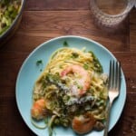 shrimp linguine with spring vegetables on blue plate with fork