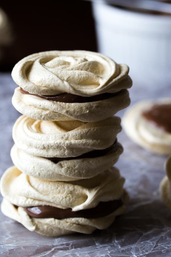side angle view of stack of three nutella meringue cookies