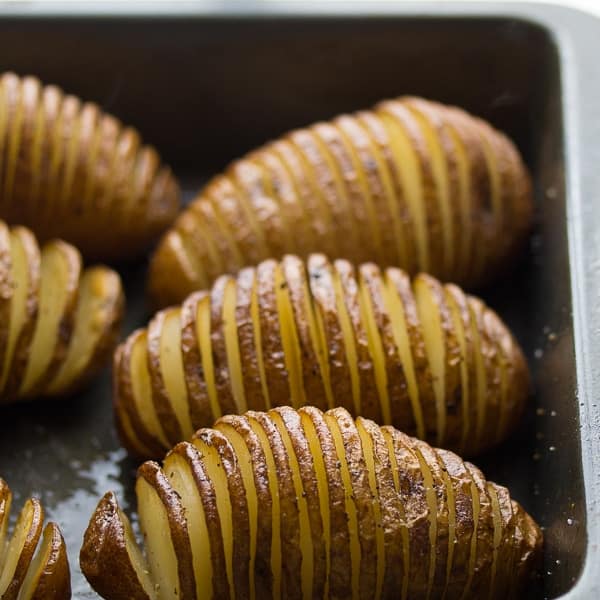 partially baked hasselback potatoes in a baking dish