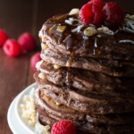 stack of coconut krispie chocolate pancakes with raspberries