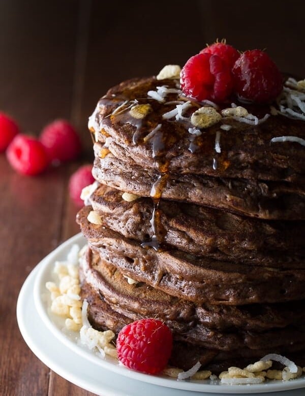 stack of coconut krispie chocolate pancakes with raspberries