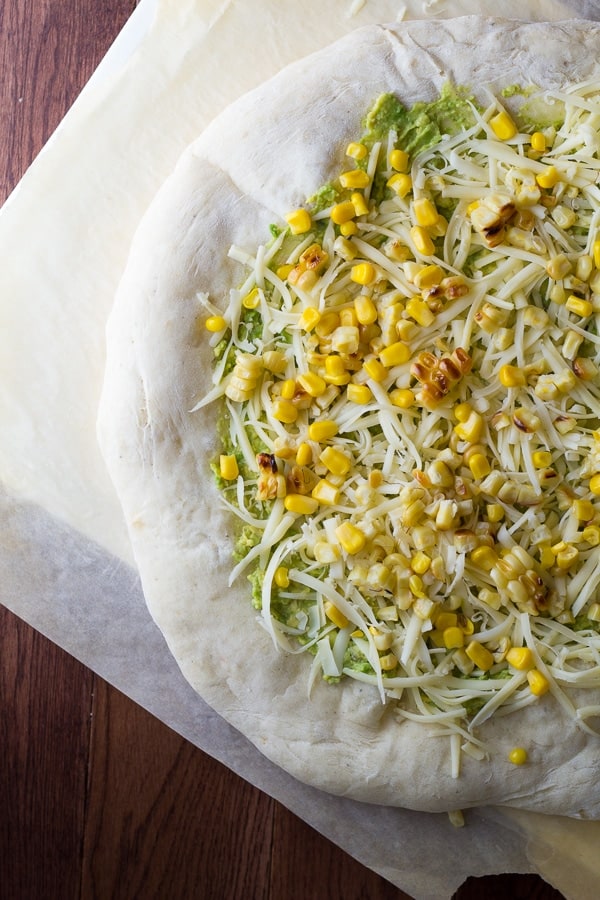 overhead shot of unbaked pizza showing how to assemble the toppings