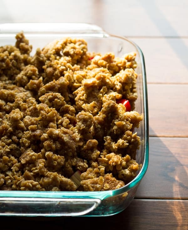 strawberry rhubarb crisp in baking dish with cookie crumb topping- before baking