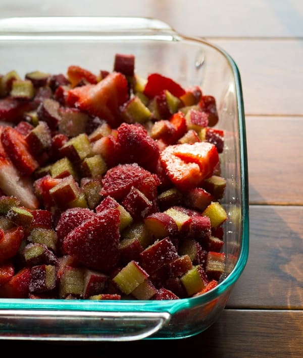 side angle view of strawberry rhubarb crisp filling in baking dish before cooking