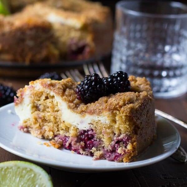 blackberry lime cream cheese coffee cake slice on white plate with fork