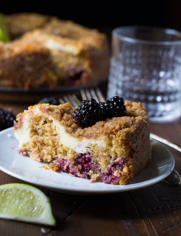 blackberry lime cream cheese coffee cake slice on white plate with fork