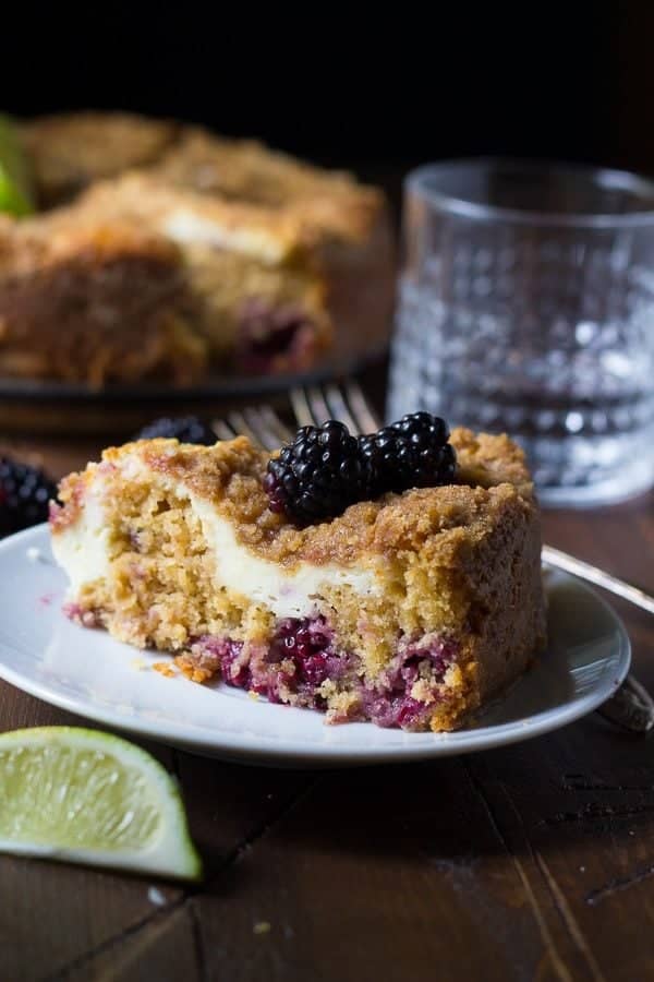 blackberry lime cream cheese coffee cake slice on white plate with fork