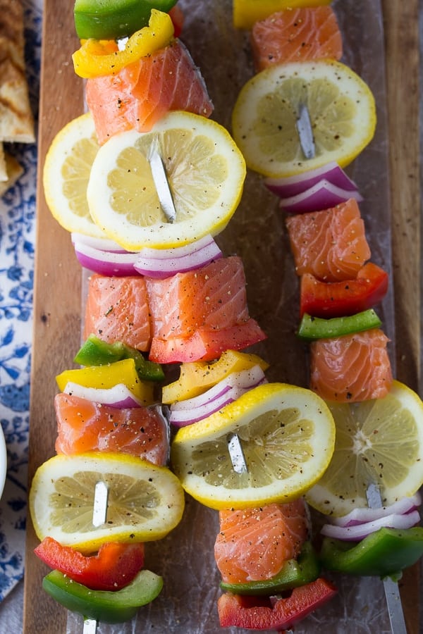 uncooked salmon skewers on cutting board