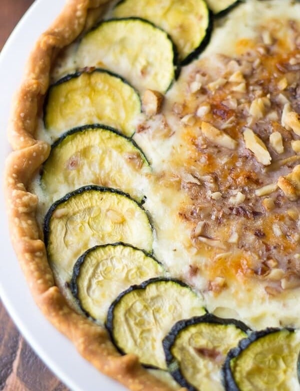 close up shot of zucchini ricotta quiche with crumbled walnuts