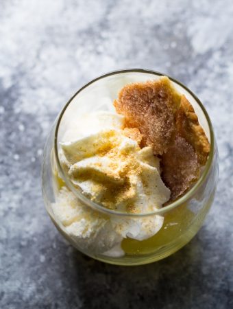 lemon meringue pie sundaes in glass on gray counter