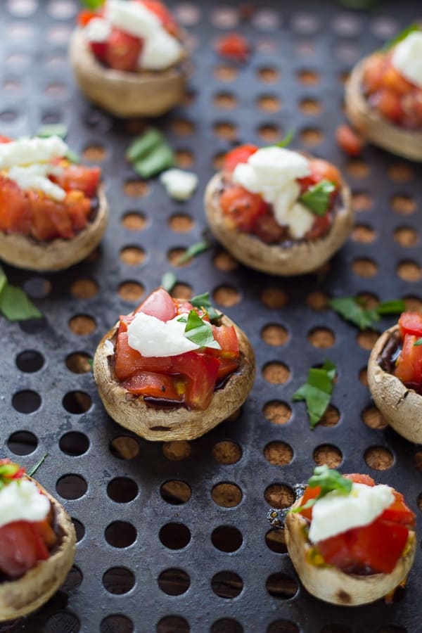 grilled mushroom caps stuffed with bruschetta and topped with goat cheese and fresh basil