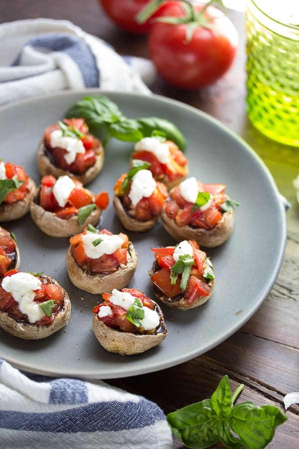 bruschetta stuffed grilled mushroom caps on a plate