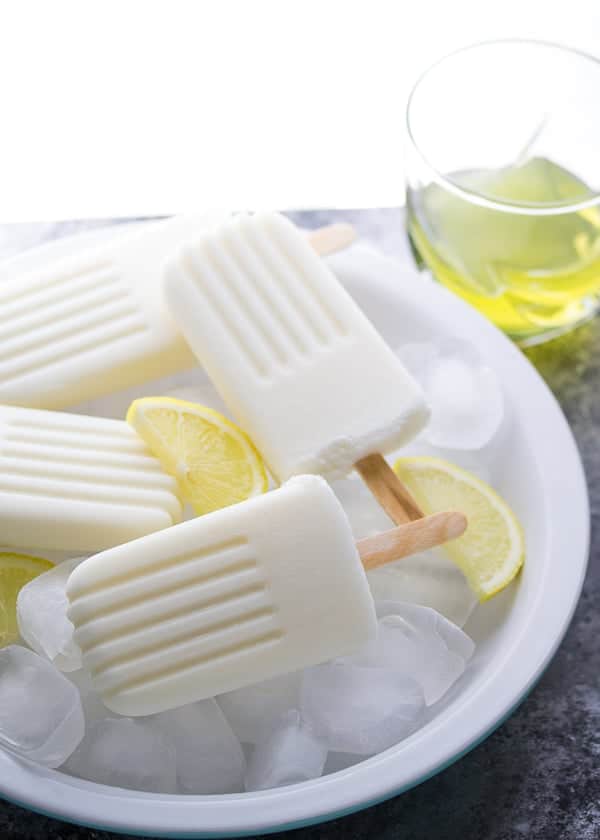 side angle view of a bowl of limoncello popsicles with ice cubes