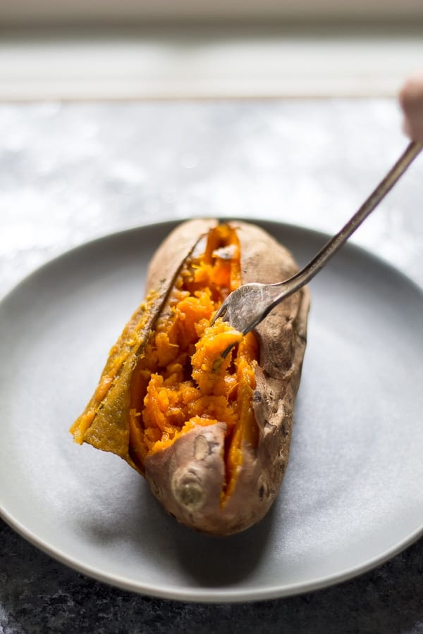 Crock Pot sweet potatoes with fork on a plate