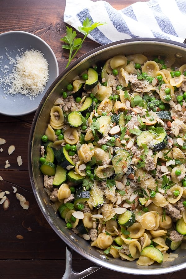 overhead view of one pan orecchiette sprinkled with parmesan cheese