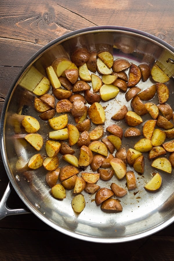 showing the process of browning the potatoes in the skillet