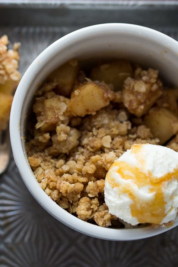 close up overhead view of single serving apple crisp with scoop of ice cream