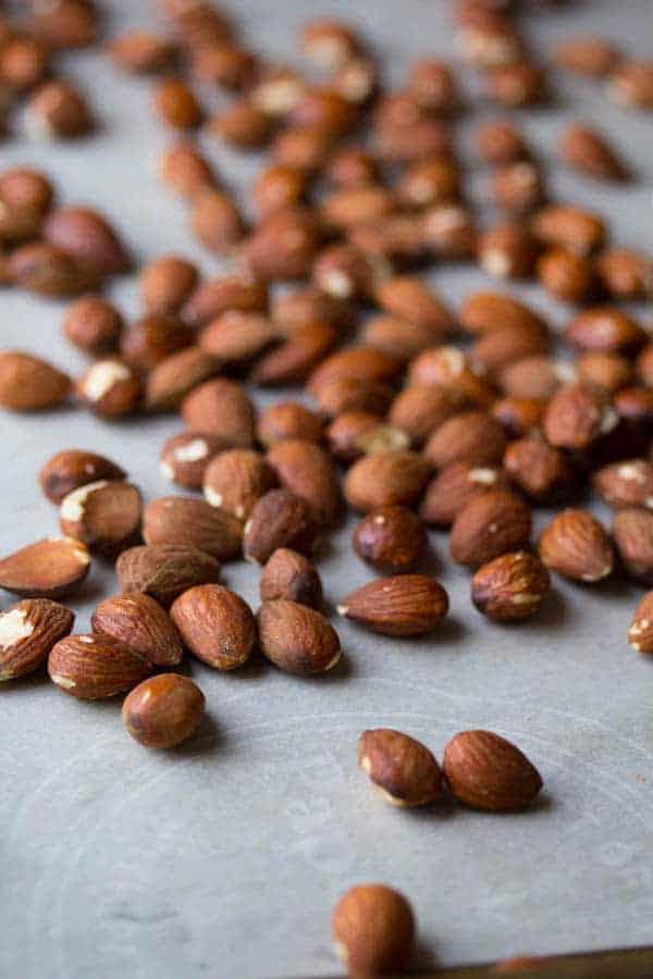 side angle view of almonds on baking sheet after roasting