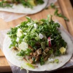 maple pork tacos with kale and brussels slaw on wood board