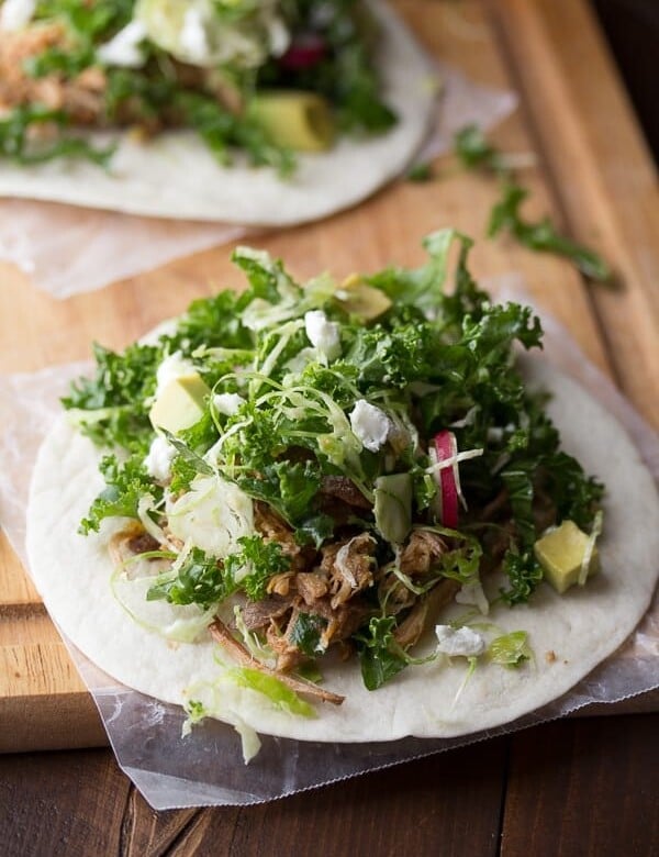 maple pork tacos with kale and brussels slaw on wood board