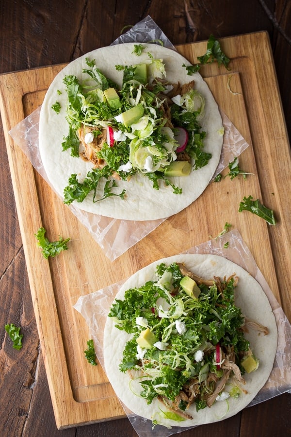 overhead view of two maple pork tacos topped with brussels sprouts slaw