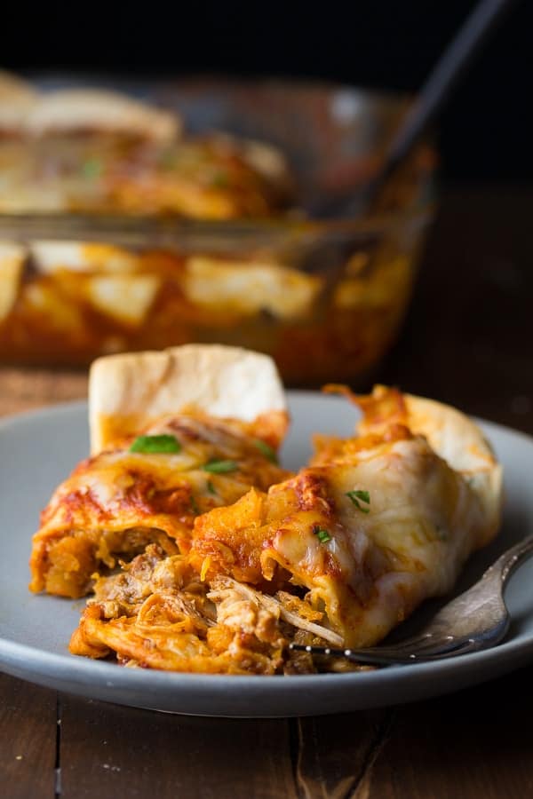 pulled pork enchiladas on a plate with fork