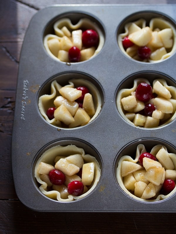 Mini Pear & Cranberry Pies in muffin tin before baking