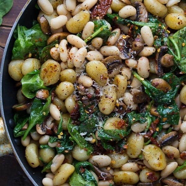 pan fried gnocchi with sundried tomatoes and white beans in large skillet