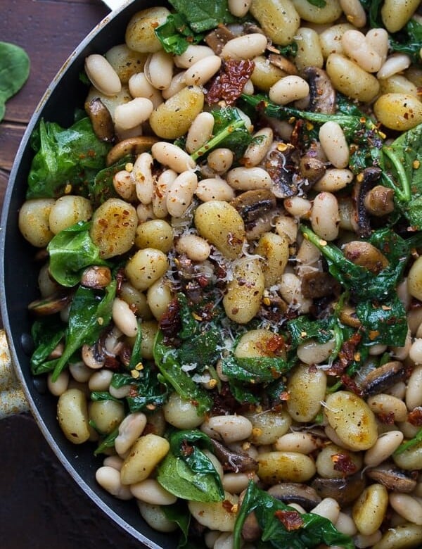 pan fried gnocchi with sundried tomatoes and white beans in large skillet