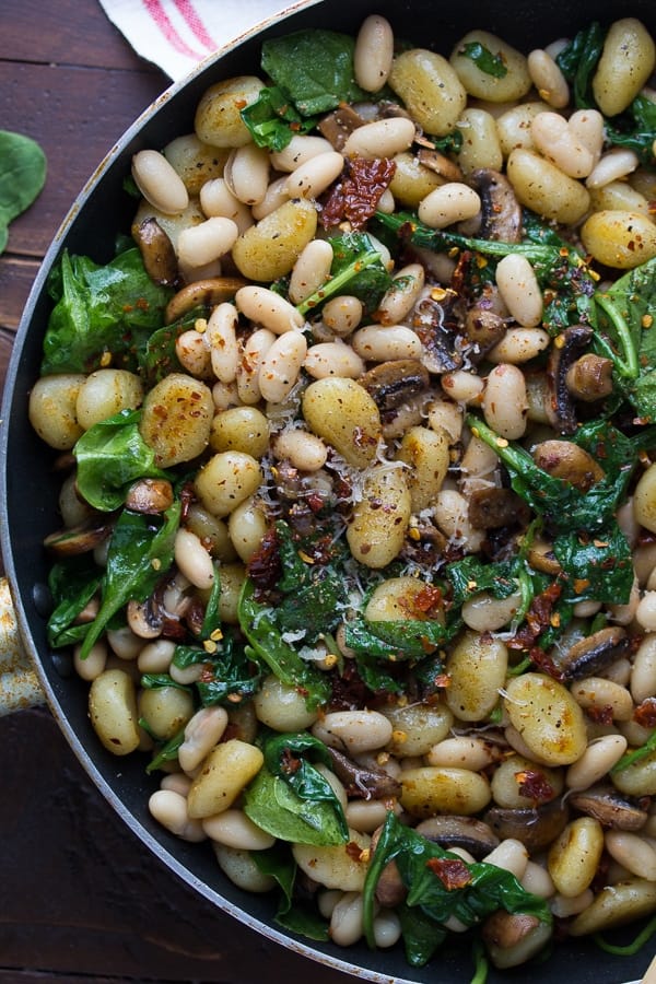 overhead view of Gnocchi With Sun dried Tomatoes and White Beans in large skillet