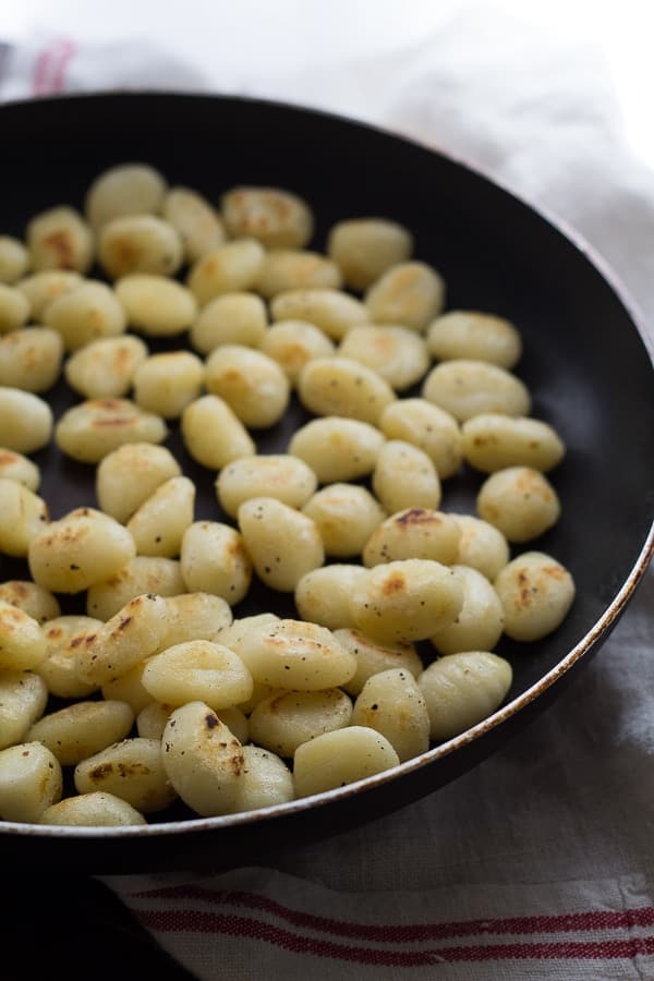 Gnocchis in a large black skillet