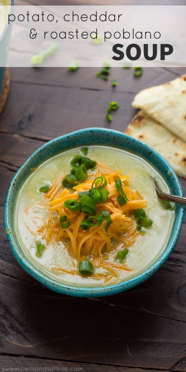 bowl of roasted poblano soup topped with orange cheddar cheese and chives