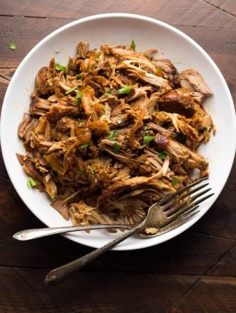 slow cooker maple pulled pork in white bowl with forks