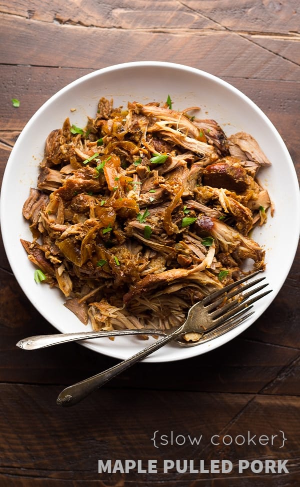 bowl of slow cooker maple pulled pork with two forks
