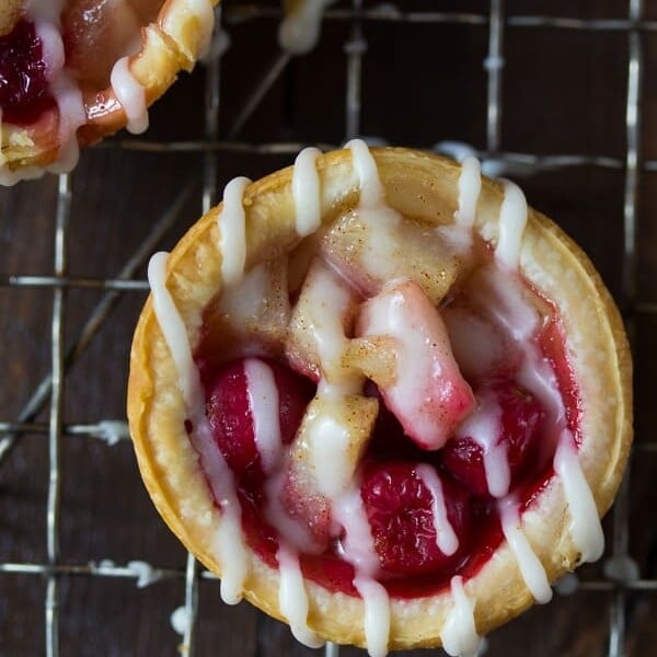 overhead shot of mini pear cranberry pie with brown butter glaze on wire rack