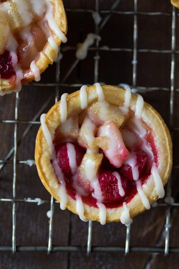 overhead shot of mini pear cranberry pie with brown butter glaze on wire rack