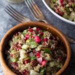 pomegranate fennel quinoa salad in wood bowl with forks