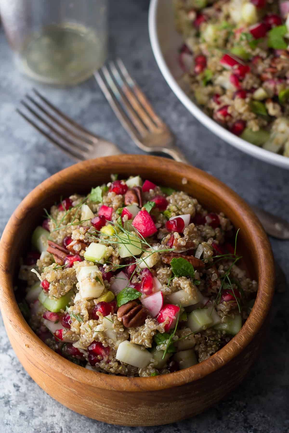 pomegranate quinoa salad in wooden bowl