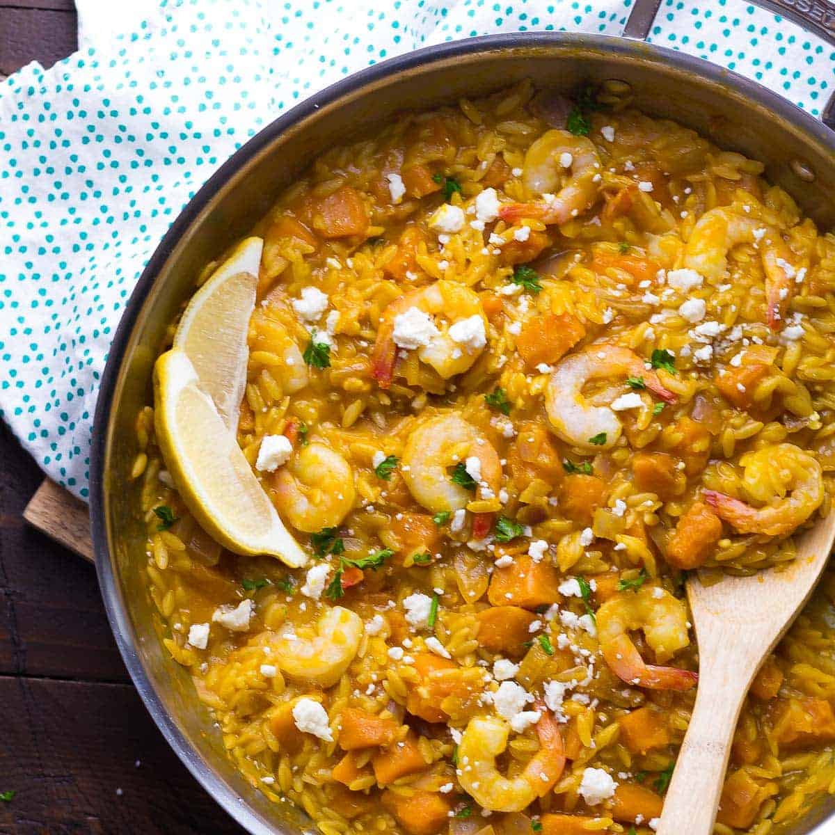 overhead shot of shrimp and squash orzo in silver pan