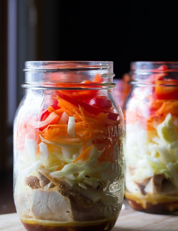 two mason jars filled with asian chicken salads