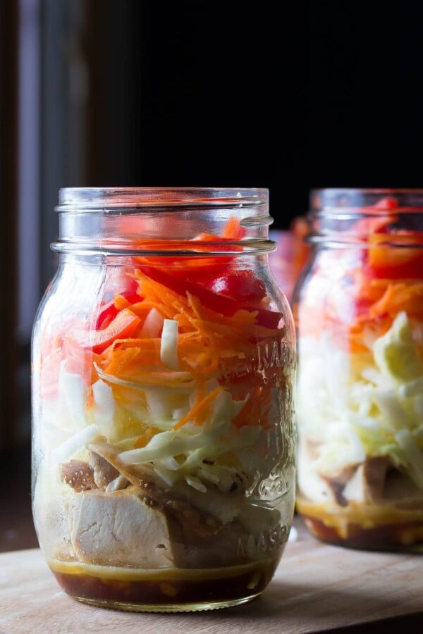 two mason jars filled with asian chicken salads