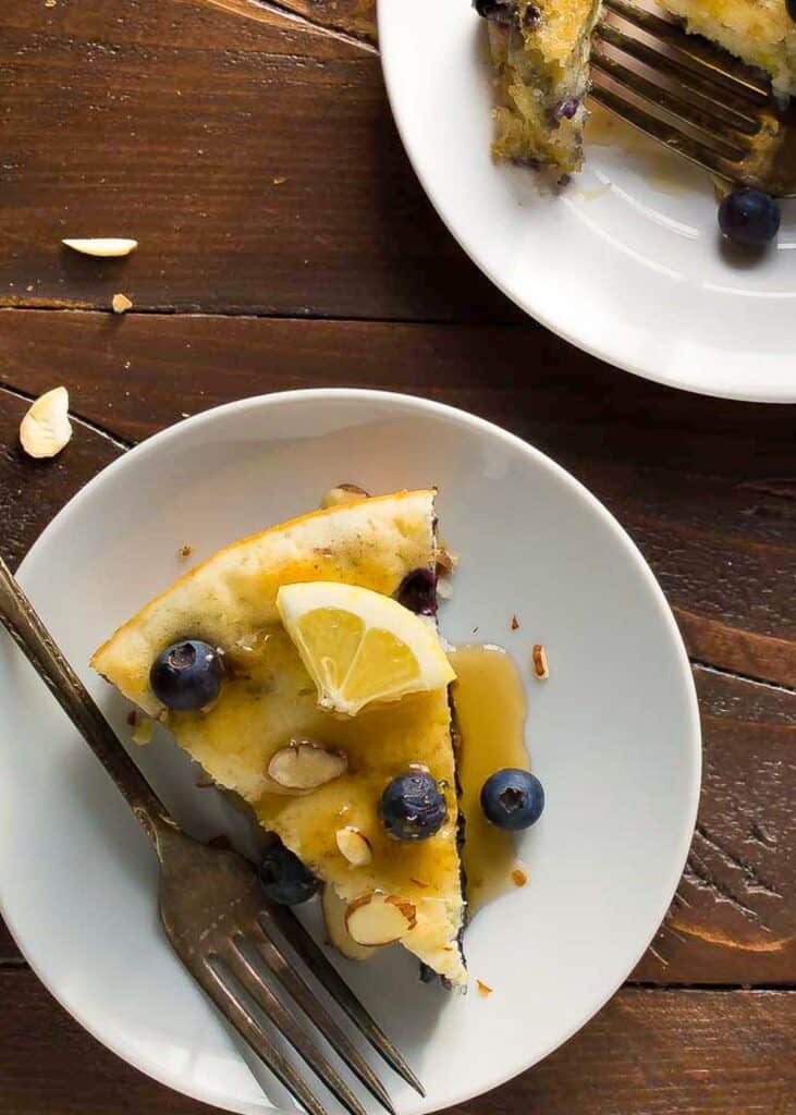 one slice of deep dish pancake on a white plate with syrup