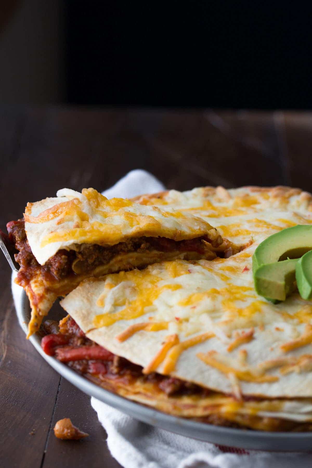 A fast and easy tortilla stack recipe that spreads leftover chili between tortillas with cheese. Ready in 25 minutes, and makes for an awesome weeknight dinner and packed lunch the next day!