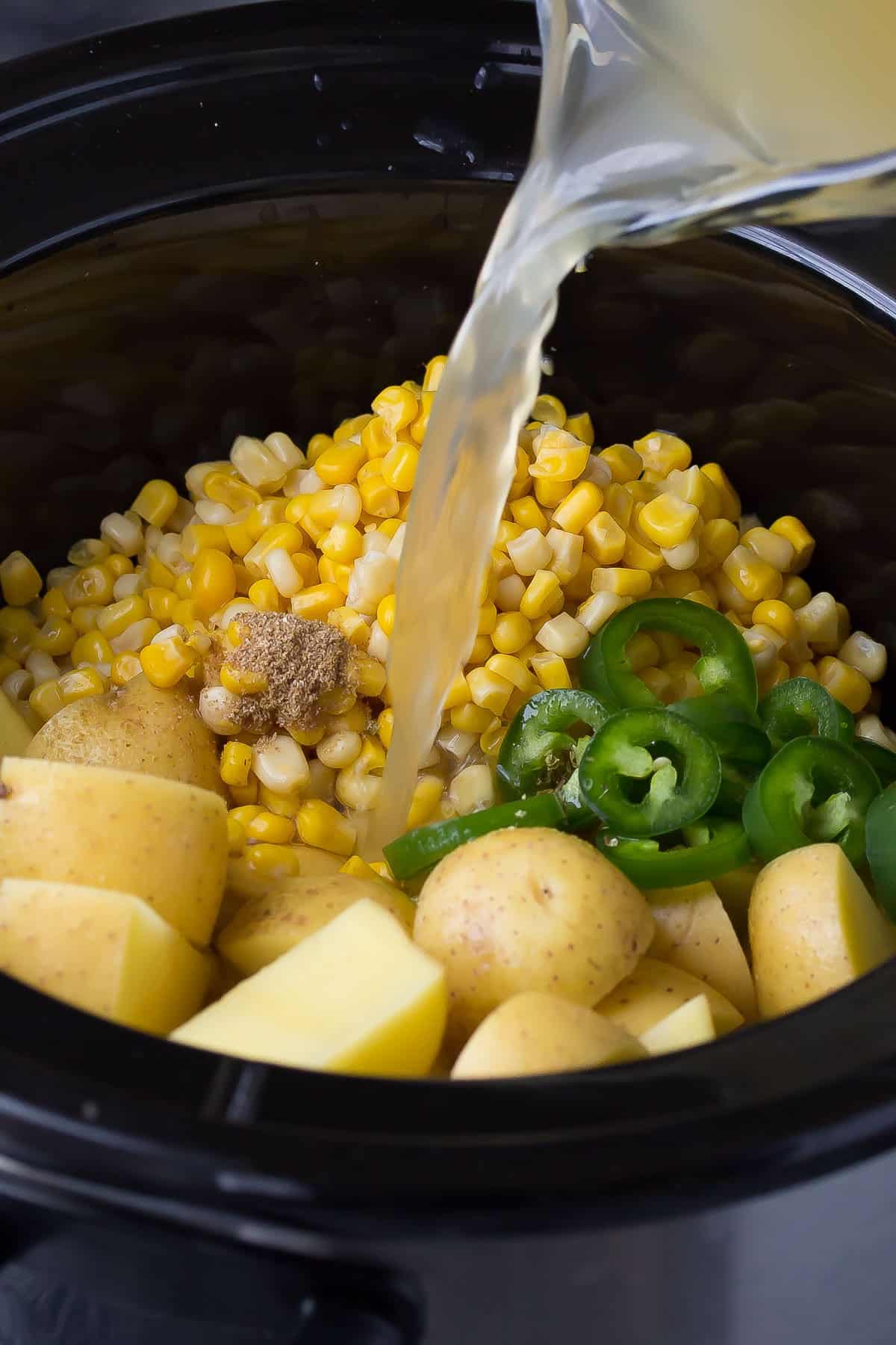 This slow cooker potato corn soup is an easy and deceptively healthy recipe that gets a boost of creaminess from Almond Breeze almond beverage, and a touch of heat from jalapenos! Only 160 calories/bowl!