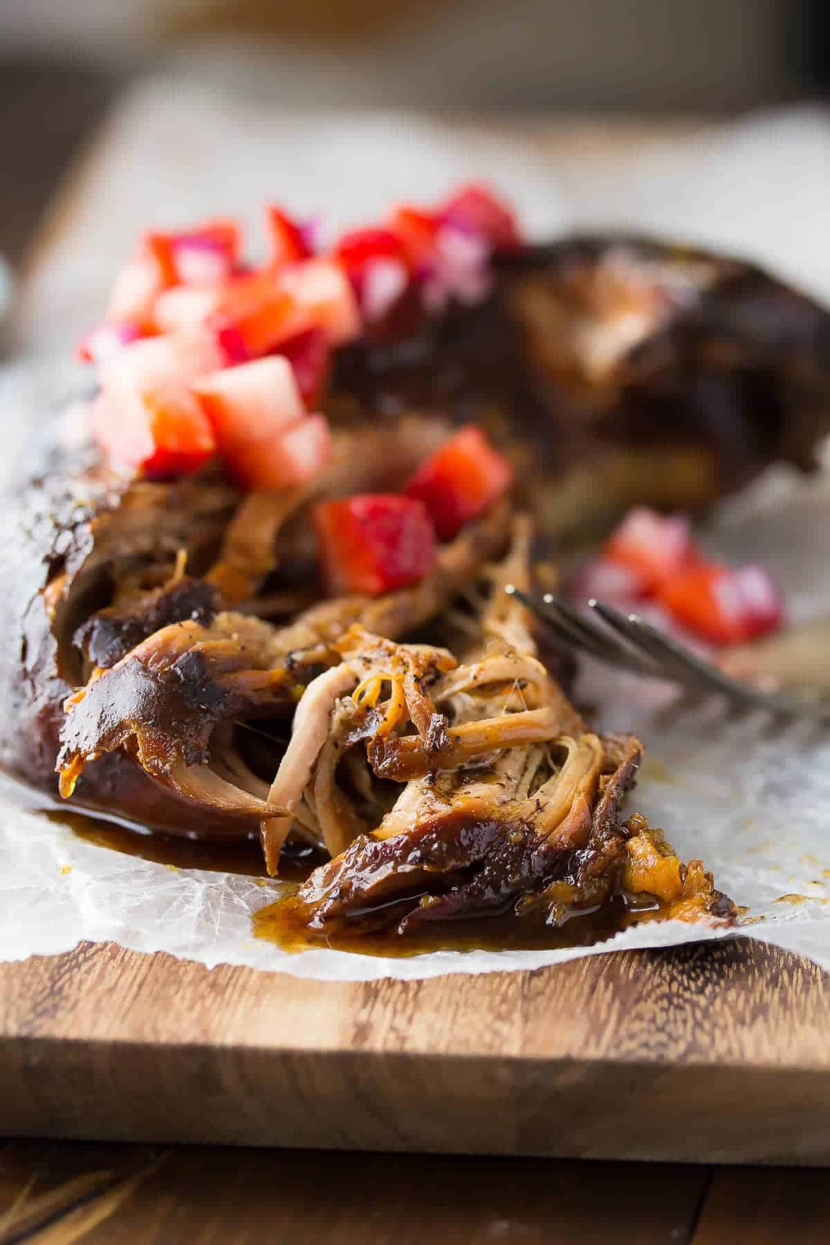 This slow cooker pork tenderloin is cooked in a tangy balsamic sauce with sweet potatoes, then topped with a fresh strawberry salsa