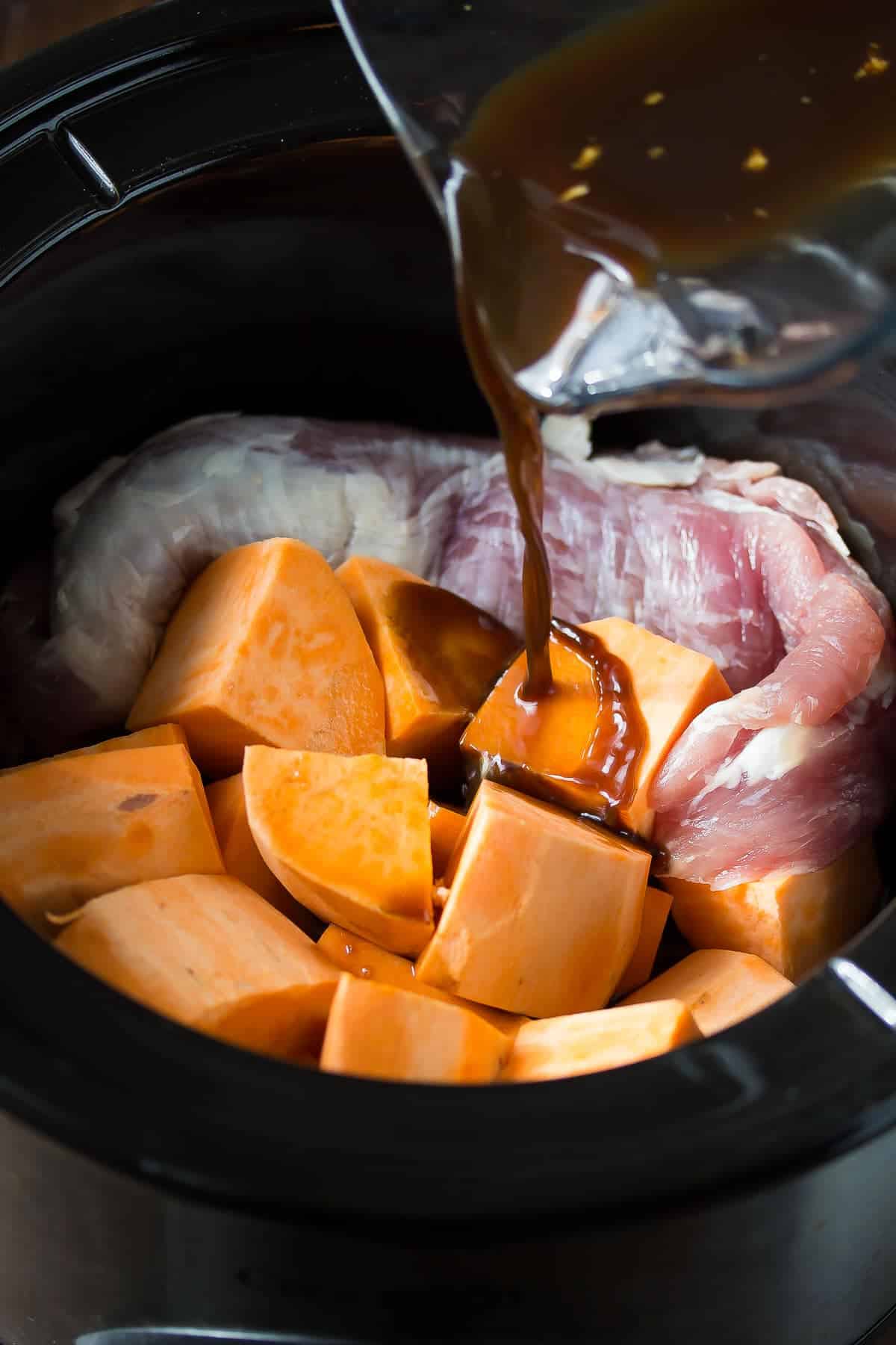 This slow cooker pork tenderloin is cooked in a tangy balsamic sauce with sweet potatoes, then topped with a fresh strawberry salsa