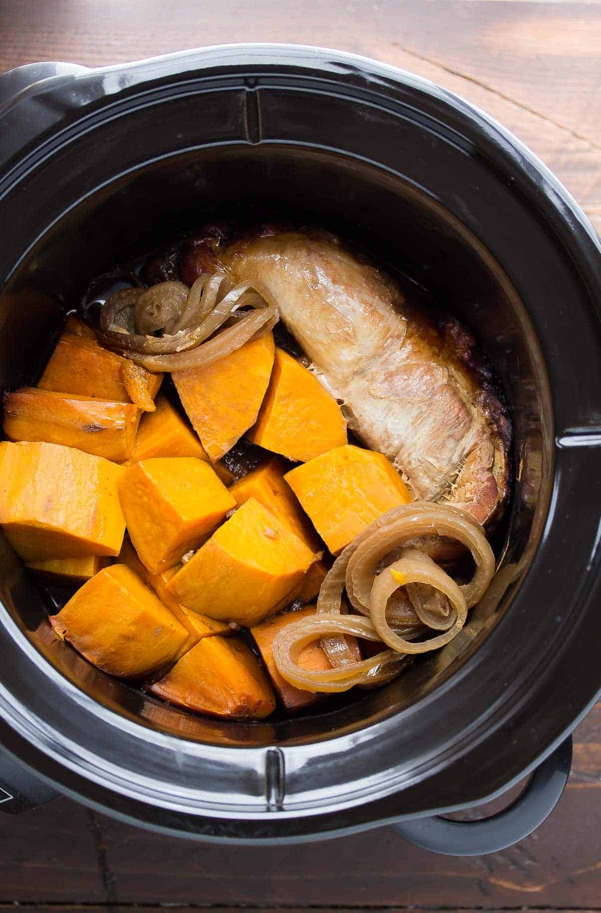 This slow cooker pork tenderloin is cooked in a tangy balsamic sauce with sweet potatoes, then topped with a fresh strawberry salsa